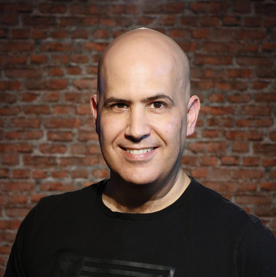 David Ginat standing in front of a brick wall